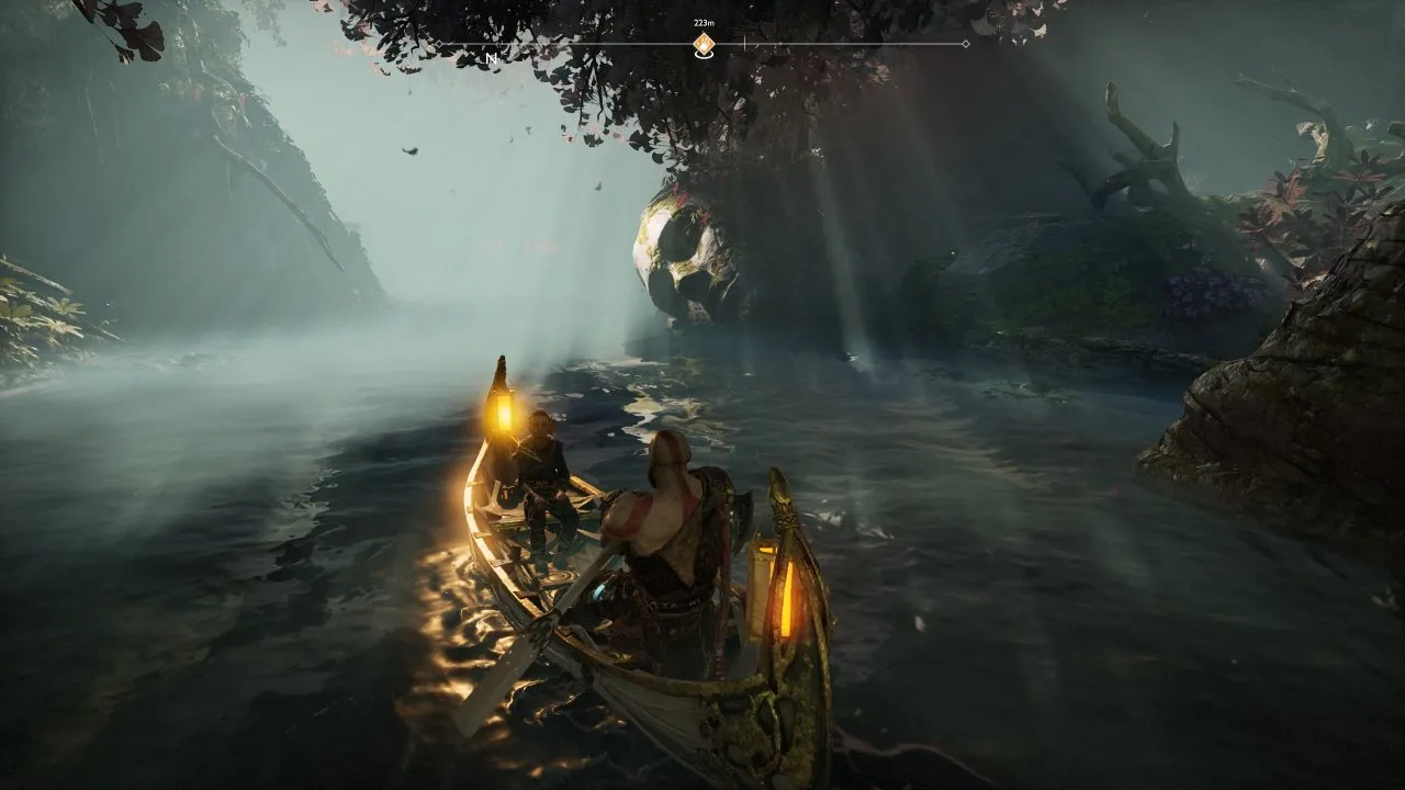 Kratos and Atreus are rowing. There is a statue remnant seen in the scene.